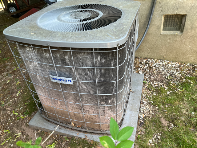 This is the combination of poor ac design and poor installation. It show bleached like looking unguarded air conditioner installed in the near proximity of dirt.